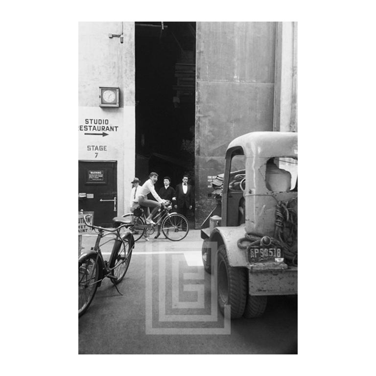 Mark Shaw Figurative Photograph - Audrey Hepburn Bicycles Sabrina Movie Set, 1953