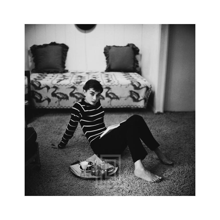 Mark Shaw Black and White Photograph - Audrey Hepburn in Striped Sweater Lounges, Arms Back, 1953