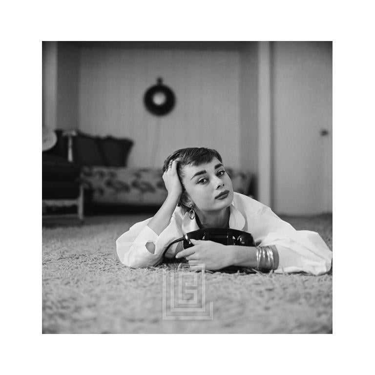 Mark Shaw Portrait Photograph - Audrey Hepburn in White Blouse with Phone, Head on Right Hand, 1953