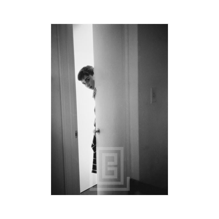 Mark Shaw Figurative Photograph - Audrey Hepburn Peeking, 1953