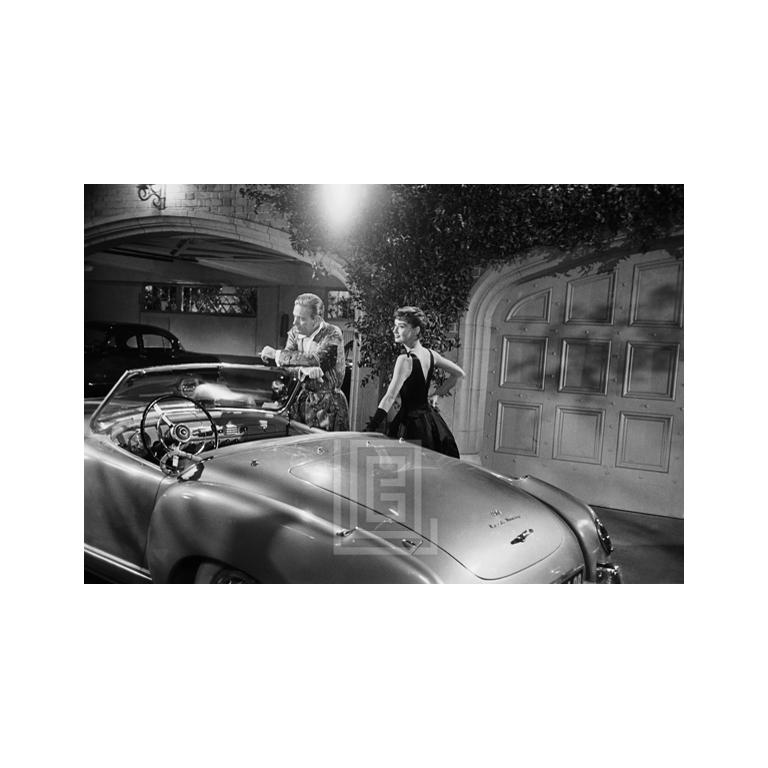 Mark Shaw Black and White Photograph - Audrey Hepburn Standing Next to Convertible, 1953