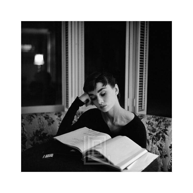 Mark Shaw Black and White Photograph – Audrey Hepburn Supine Reading, Sitting up, 1953