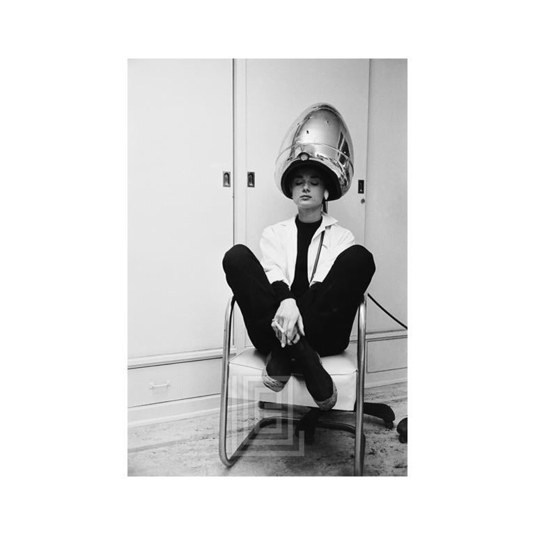 Mark Shaw Figurative Photograph - Audrey Hepburn Under the Dryer Holding Cigarette, 1953