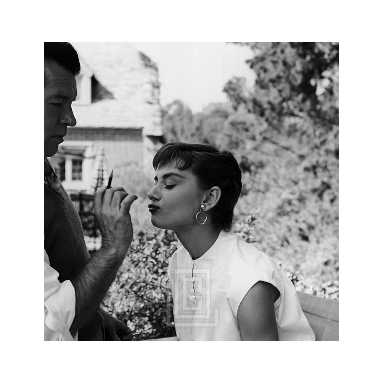 Mark Shaw Figurative Photograph - Audrey Hepburn, Wally Westmore on the Set of Sabrina, 1953