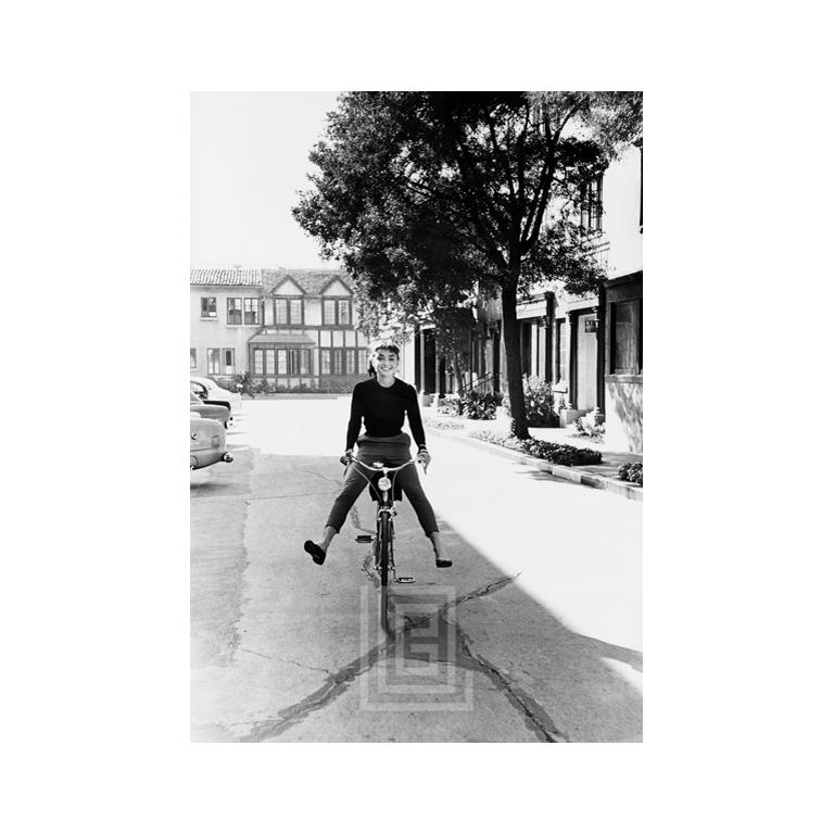 Mark Shaw Black and White Photograph - Audrey on Bicycle, 1953