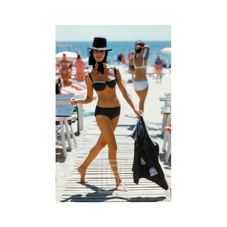 Mark Shaw Figurative Photograph - Black Bikini on St. Tropez Boardwalk 1961
