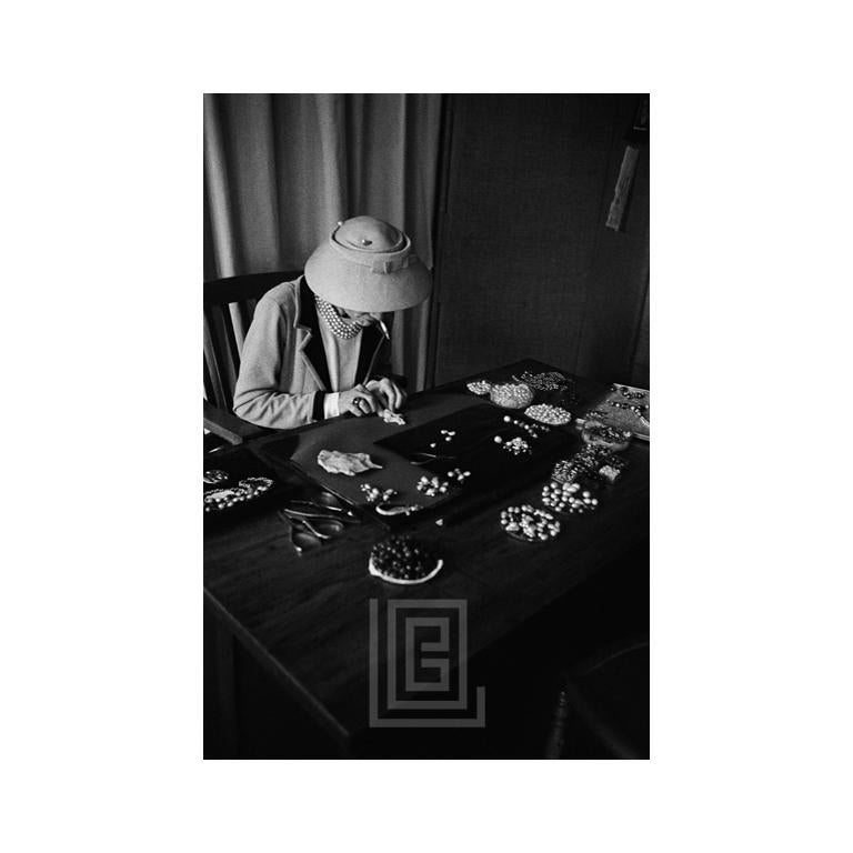 Mark Shaw Black and White Photograph - Coco Chanel Creates Jewelry, 1957