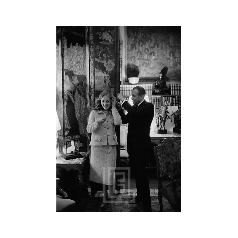 Coco in Her Wall of Mirrors Alone, 1957 -- Photographer Mark Shaw adjusts French film actress Jeanne Moreau's hair. Mark Shaw's informal, grainy, black and white images of Coco Chanel were created using an unobtrusive 35mm camera and film processing