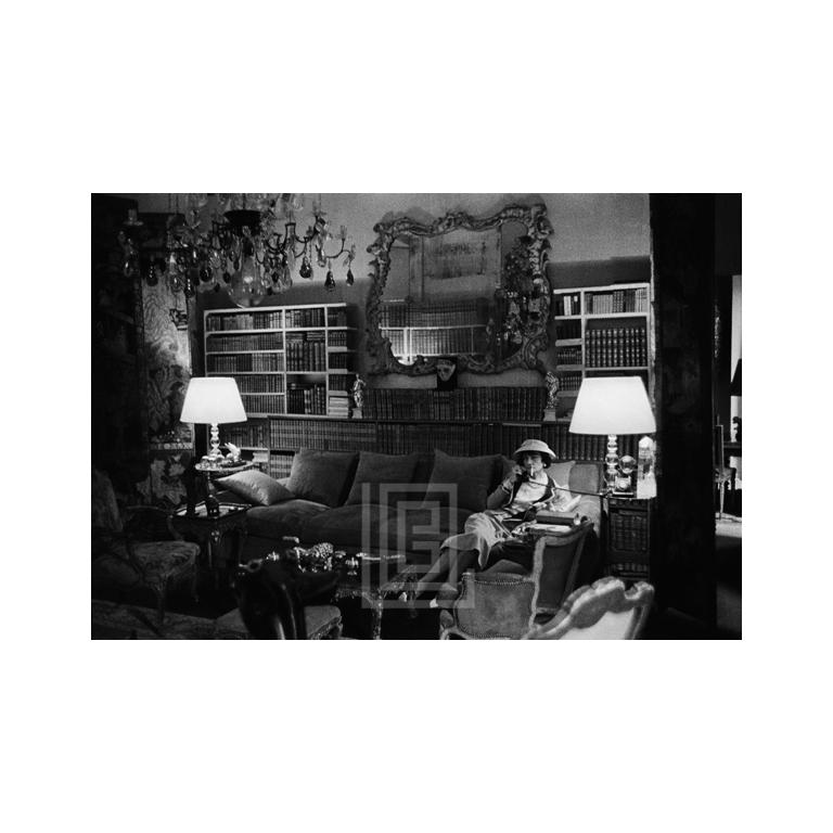 Mark Shaw Portrait Photograph - Coco Chanel Sits on Divan, 1957