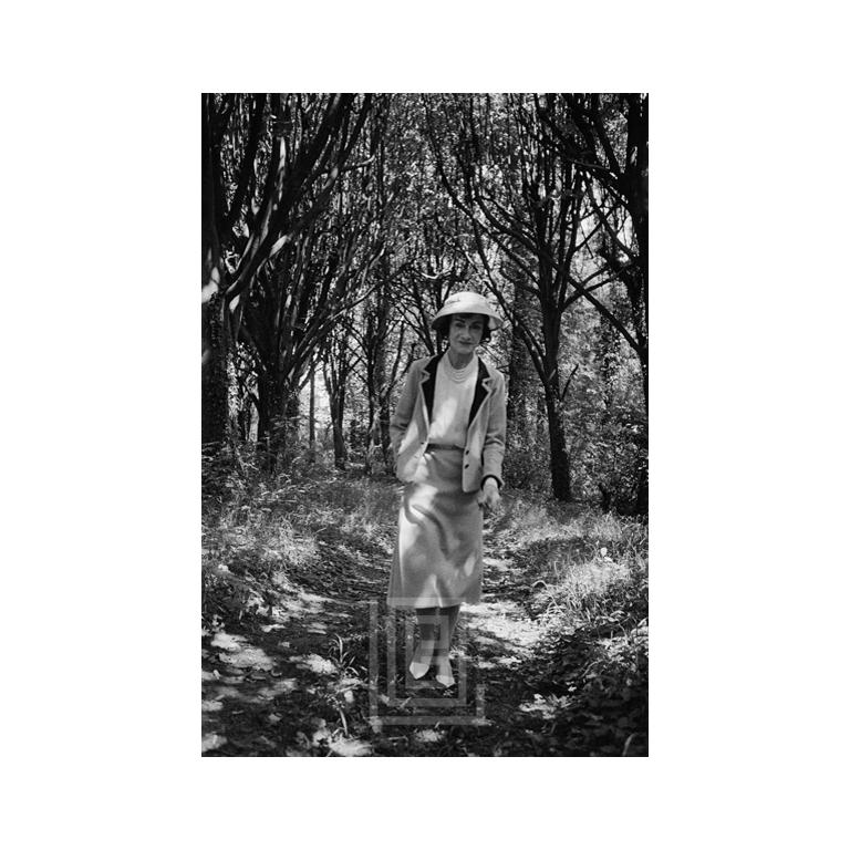 Mark Shaw Black and White Photograph - Coco Chanel Strolls Alone, 1957