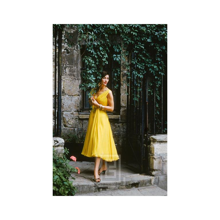 Mark Shaw Figurative Photograph - Desses Yellow Chiffon in Courtyard, 1955