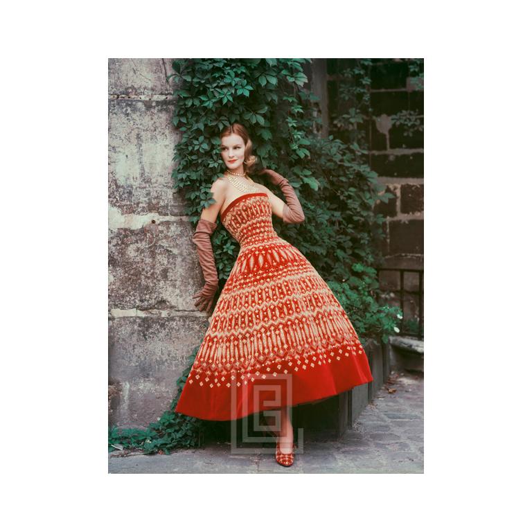 Mark Shaw Figurative Photograph - Dior Lavish Gold on Red Velvet in Courtyard, 1955