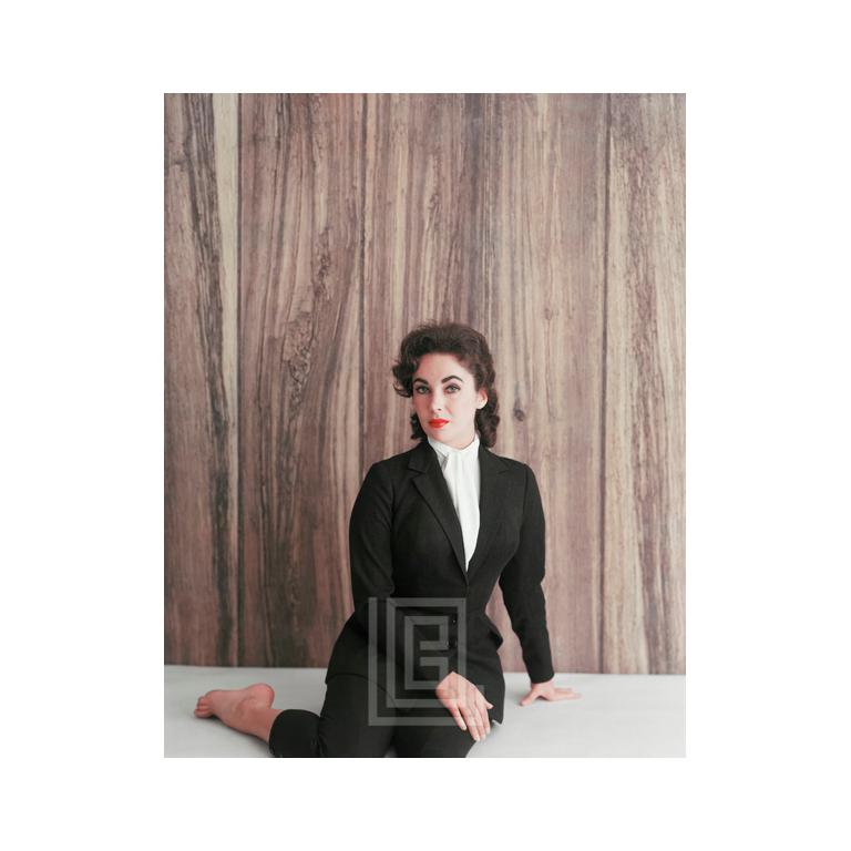 Color Photograph di Mark Shaw - Elizabeth Taylor in abito nero, seduta di lato, 1956