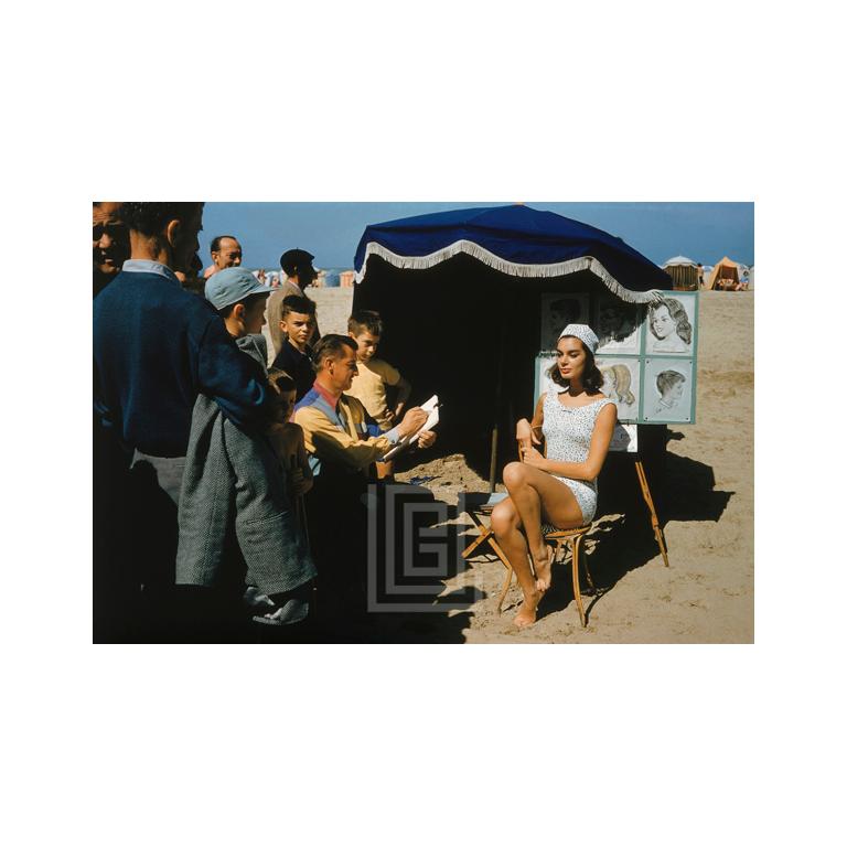 Mark Shaw Color Photograph - Givenchy clad Model is Sketched at Trouville, 1957