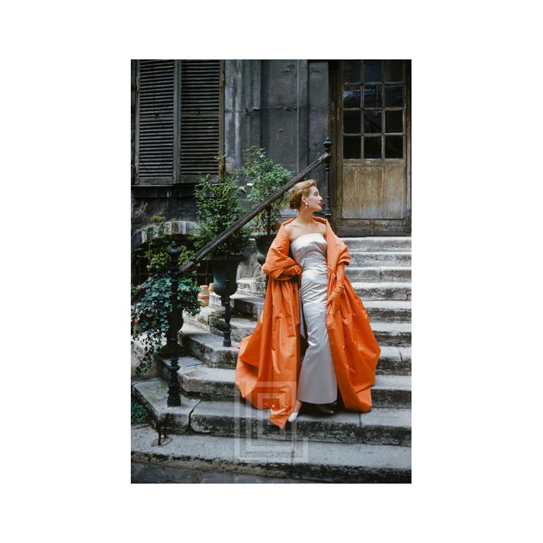 Mark Shaw Figurative Photograph - Givenchy Rust Cape in Courtyard, 1955