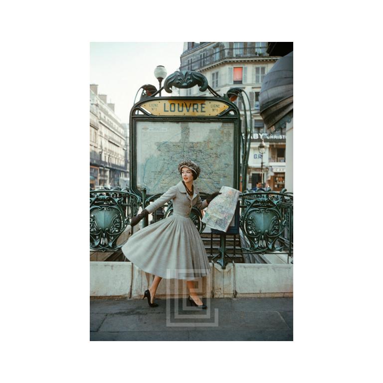 Mark Shaw Figurative Photograph – Graues Dior Outside Paris Louvre Metro, 1957