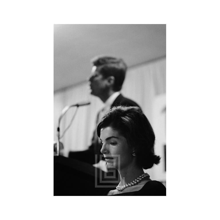 Mark Shaw Black and White Photograph - Kennedy, Jackie with JFK at Podium, 1959