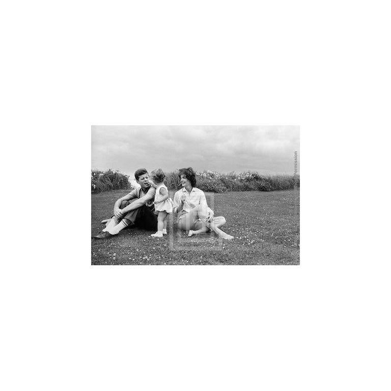 Mark Shaw Black and White Photograph - Kennedys, Caroline Feeds Flower to John, Jackie Looks on, 1959