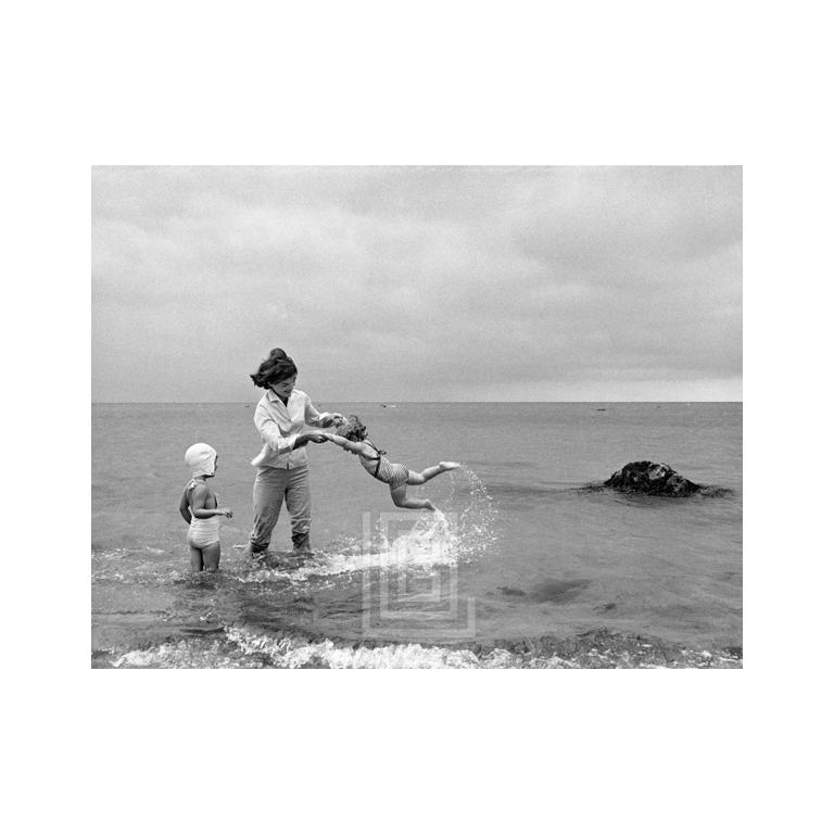 Mark Shaw Figurative Photograph - Kennedys, Hyannis Beach, Jackie Swinging Caroline with Cousin in Water, 1959