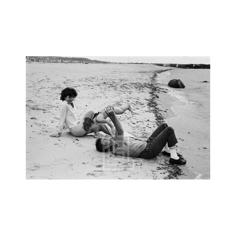 Mark Shaw Figurative Photograph - Kennedys, John Lifts Caroline on Beach