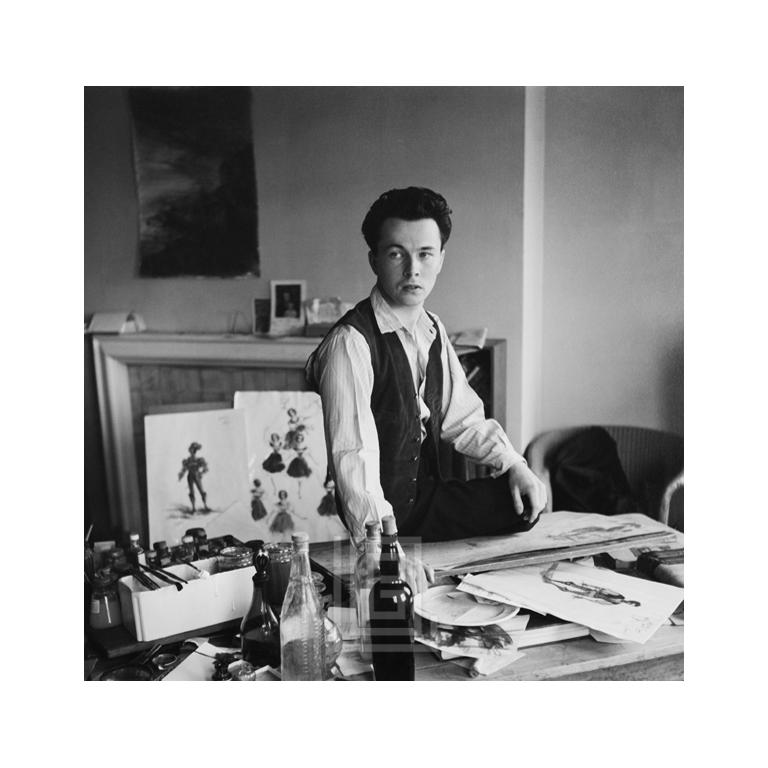 Mark Shaw Black and White Photograph - Male Illustrator Sitting at Work Table
