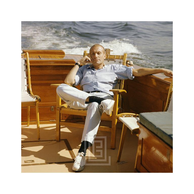 Mark Shaw Seated on Boat. Image size is 10" x 10" (for 11" x 17" paper size). All Mark Shaw prints are made to order in limited editions on Hahnemuhle photo rag paper. Each print is Estate stamped on the back and signed and numbered by David Shaw,