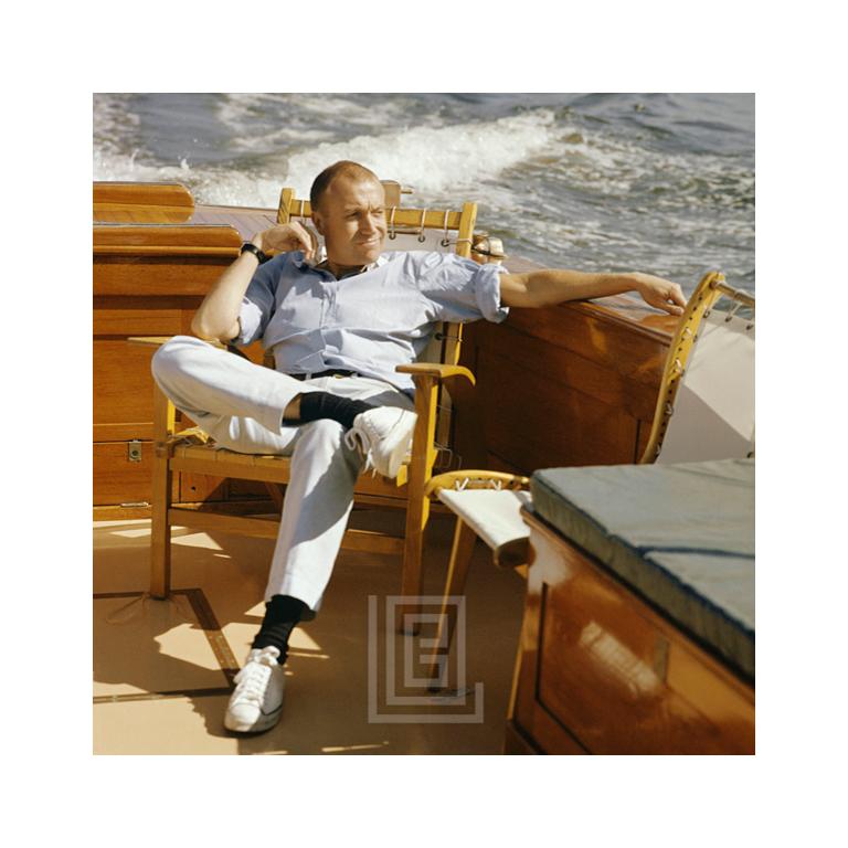 Mark Shaw Seated on Boat, Looks Left. Image size is 10" x 10" (for 11" x 17" paper size). All Mark Shaw prints are made to order in limited editions on Hahnemuhle photo rag paper. Each print is Estate stamped on the back and signed and numbered by