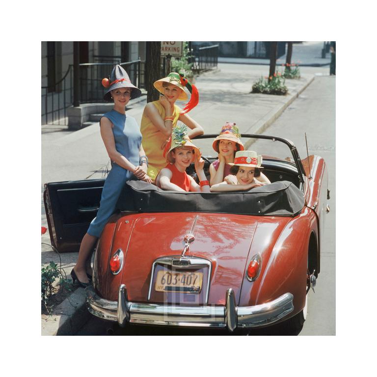 Mark Shaw Figurative Photograph - Red Jaguar, Beach Hat Models, 1959