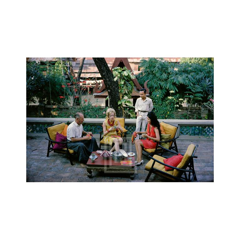 Mark Shaw Color Photograph - Tiger Morse in Yellow, Tea with Jim Thompson 01, 1962