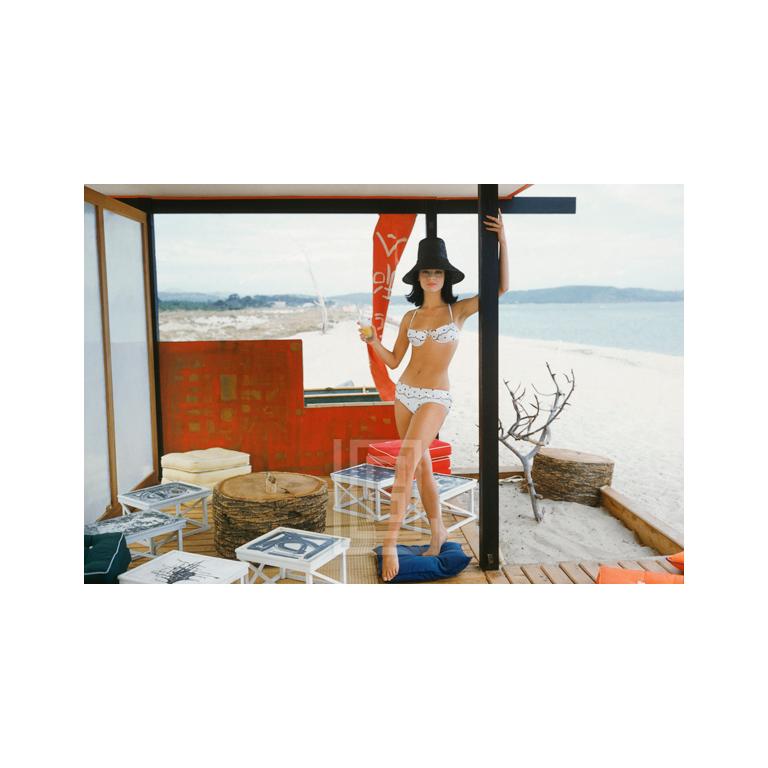 Mark Shaw Figurative Photograph - White Bikini in St. Tropez Beach Cabana 1961