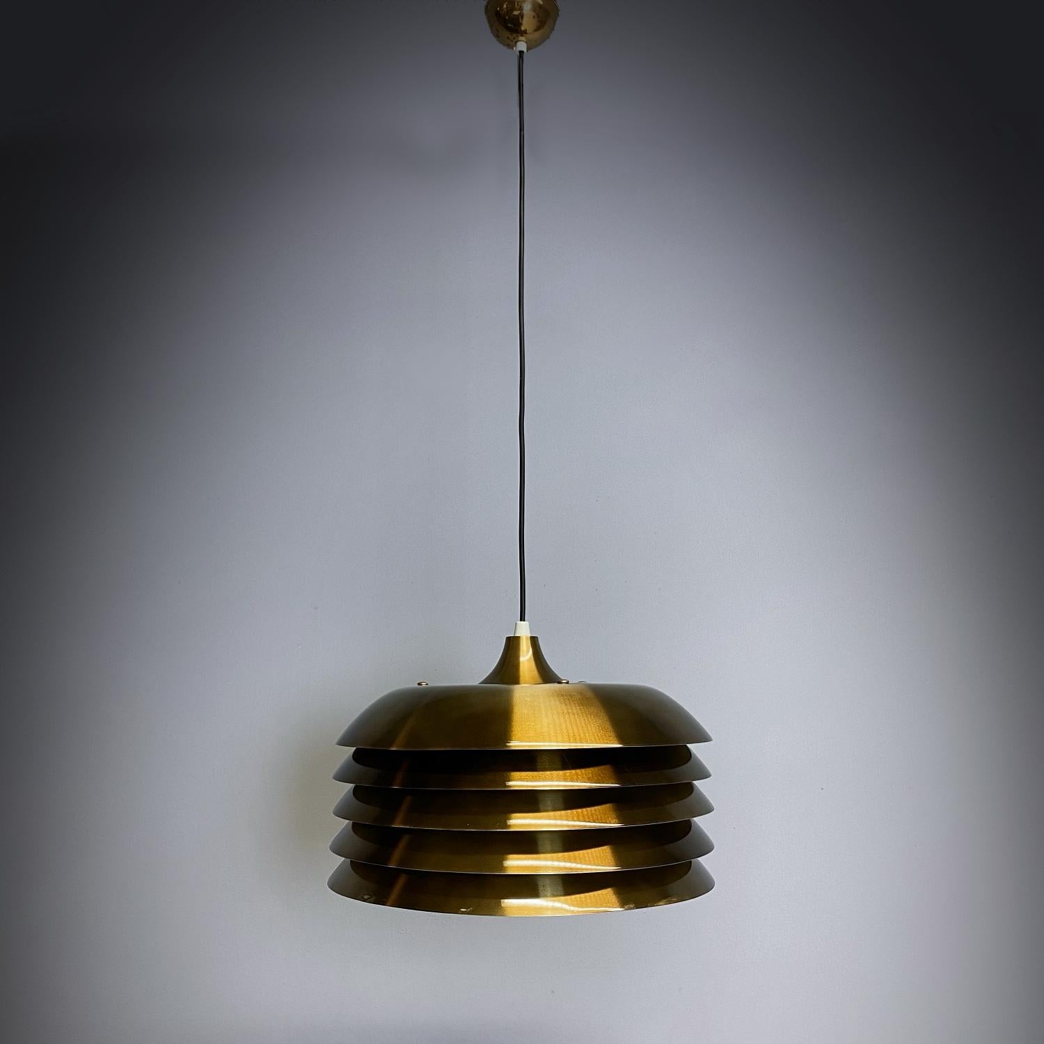 Elegant Space Age pendant lamp designed by Hans-Agne Jacobsson for Markaryd and manufactured in 1970s, so it was one of the first edition. The lamp is made of brass plated slats that provide a smooth and wonderful large area light. The lamp is in