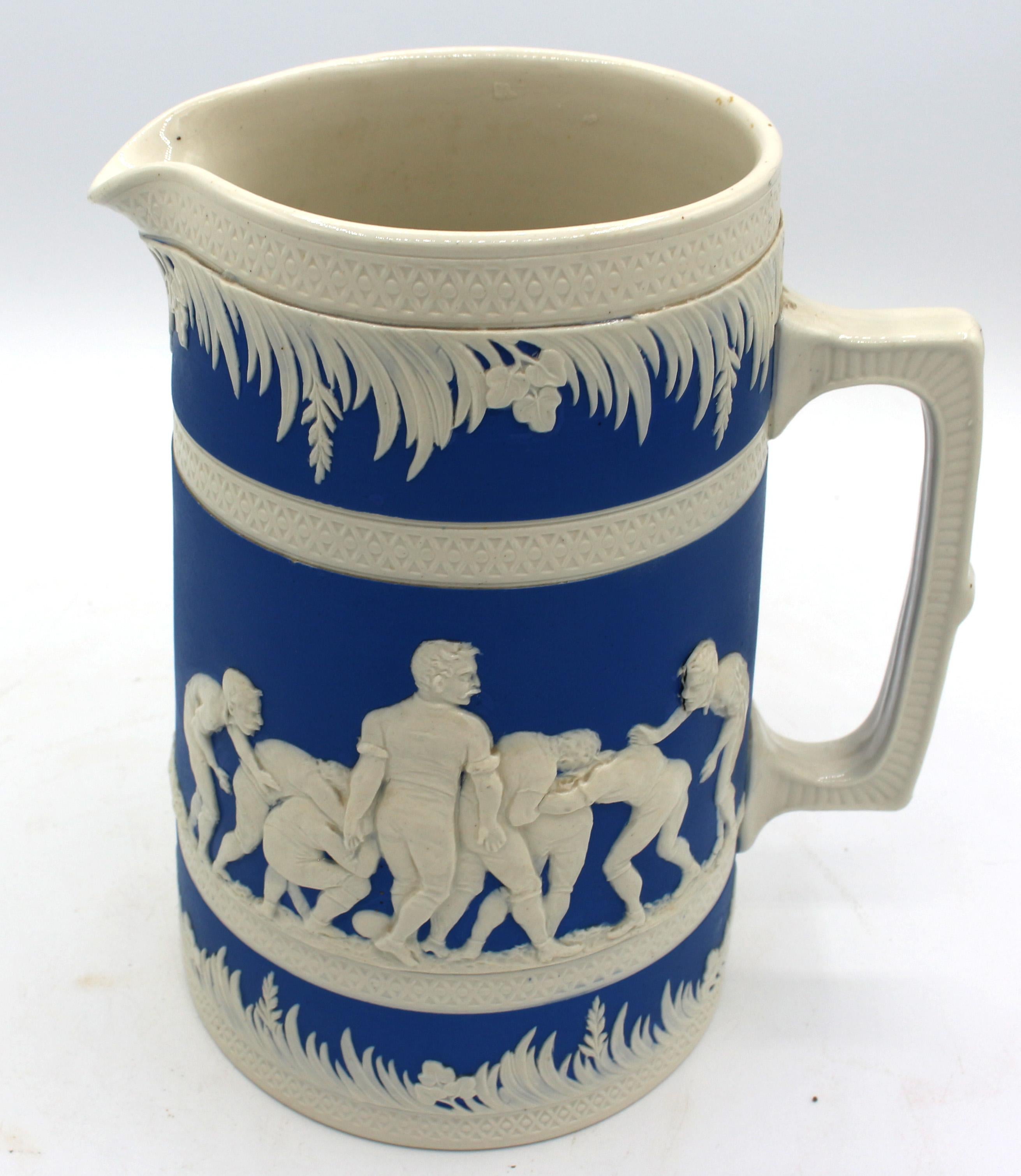 Marked 1895 American Football motif ceramic pitcher by Copeland for Jones, McDuffee & Stratton, Boston. A rarely found American market piece - glazed & matte finished, creamy white on deep blue. Marked 1895, Football, Copyright, J McD & S