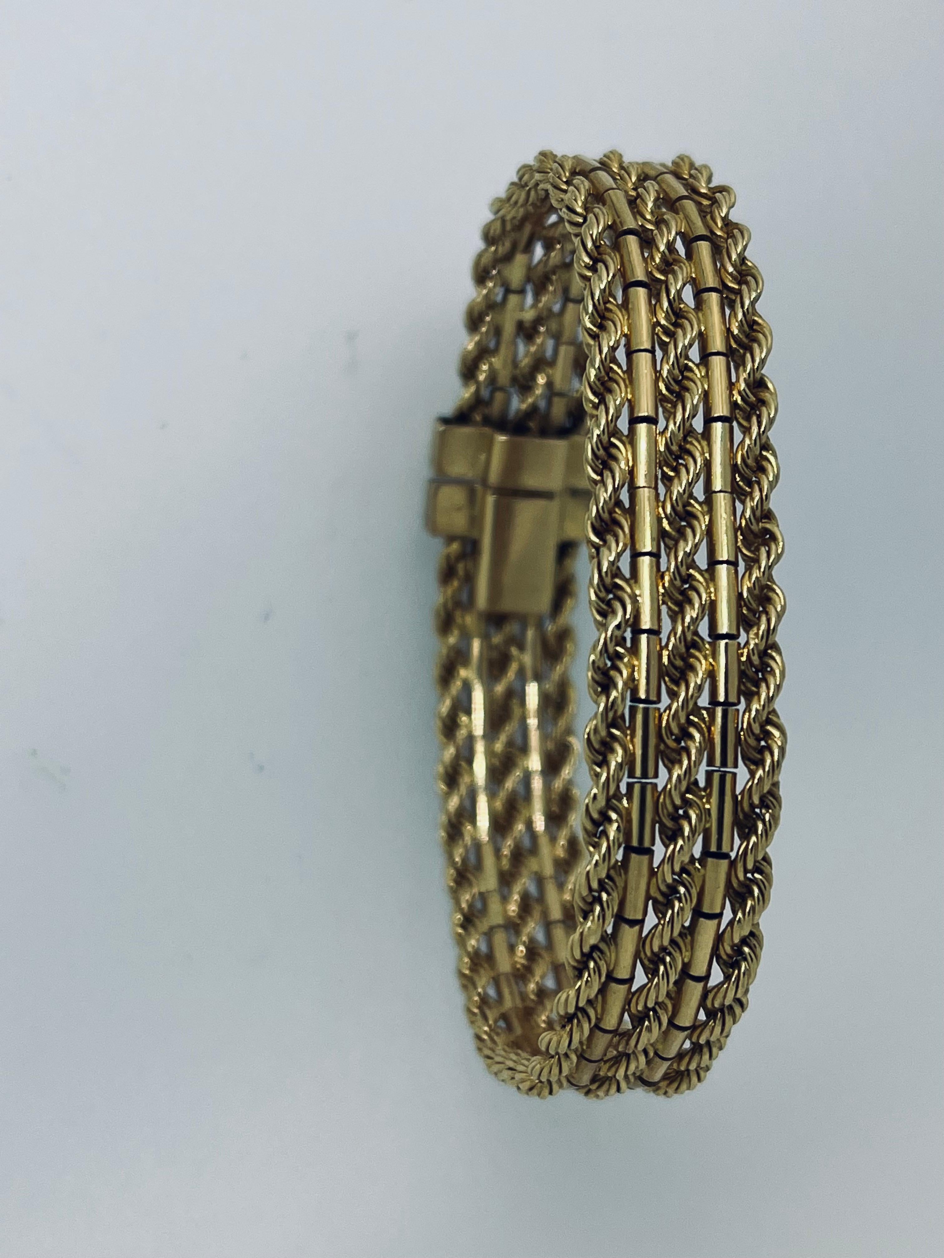Marked 18ct three row rope gold bracelet, circa 1960s, 30.9 grammes, 17.8cm length, 21mm width. Unbranded, made in Italy. Hallmark: stamp of a head with a helmet representing a hallmark and it was tested with a gun that confirmed 18ct. Price:
