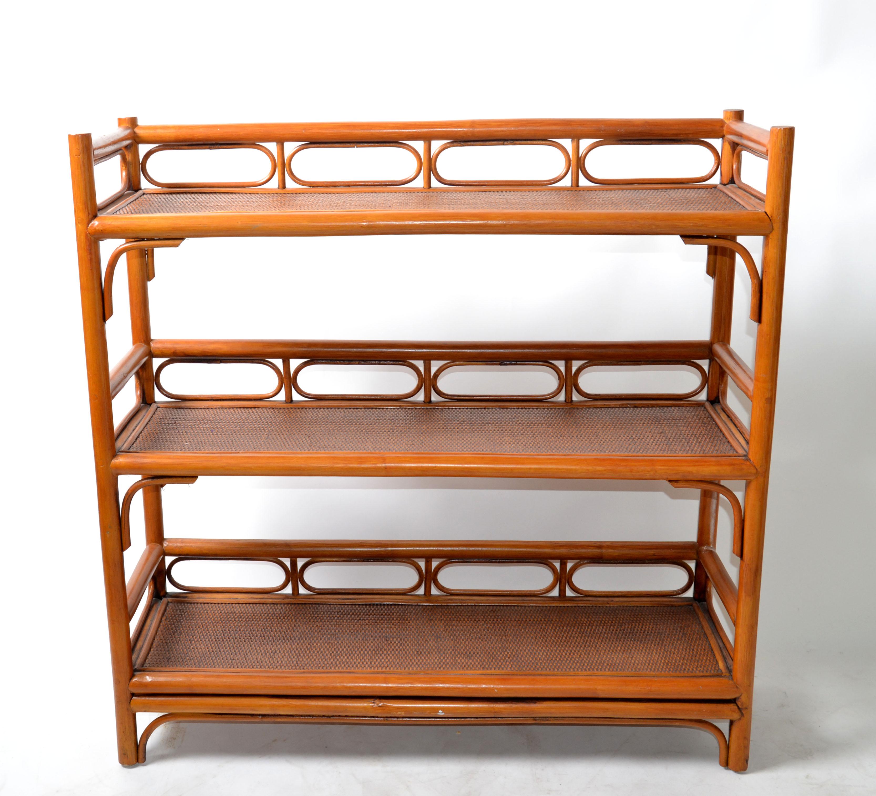 American Leader's casual furniture Mid-Century Modern 3-tier storage shelf, bookcase in cane and bent Rattan wood. 
Great also for your bedroom inside the Dressing Room. 
Original maker's label underneath.
Space in between all levels is 12