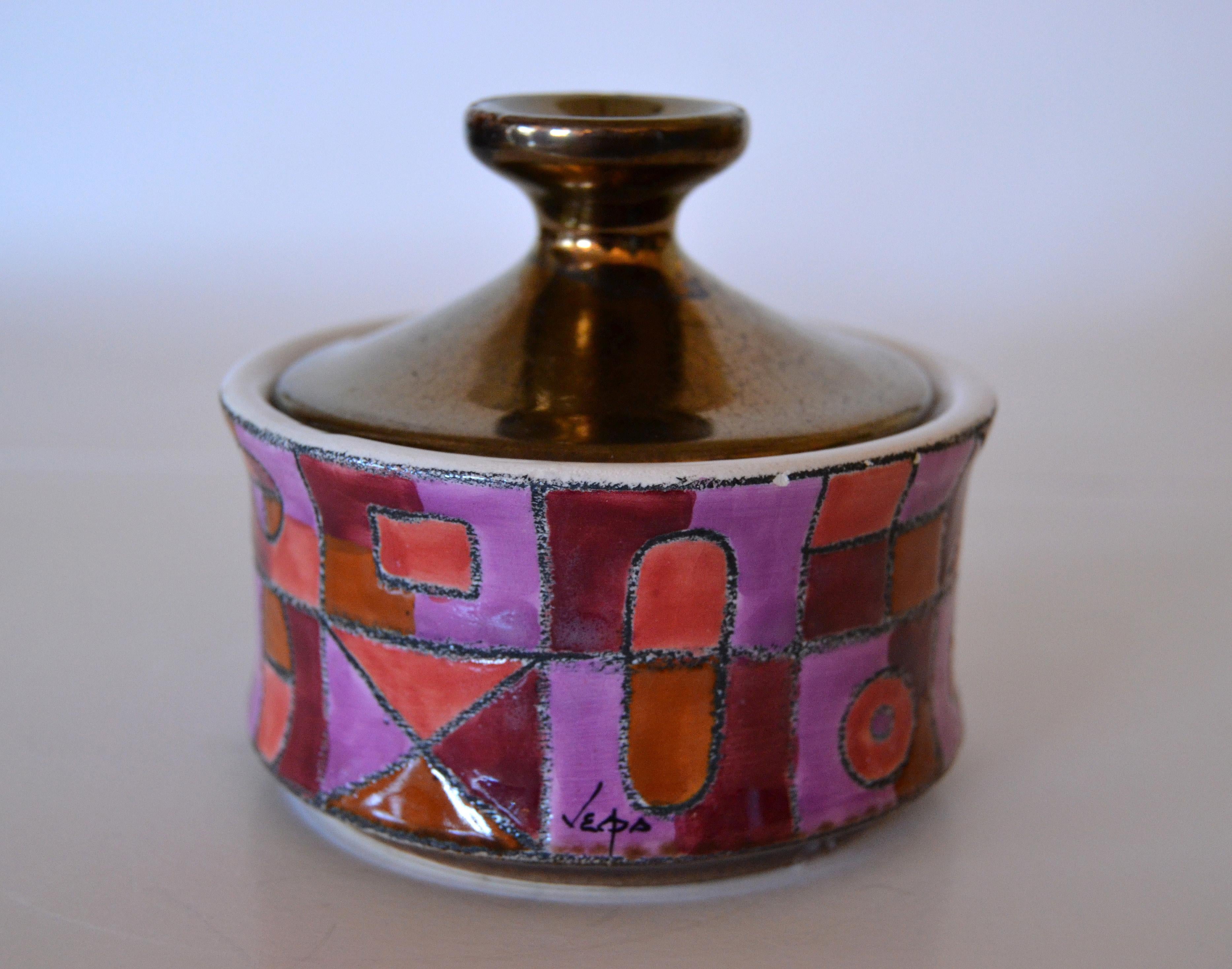 Marked ceramic sugar bowl with lid in purple, bronze and shades of maroon color.
Trademark at the base.
