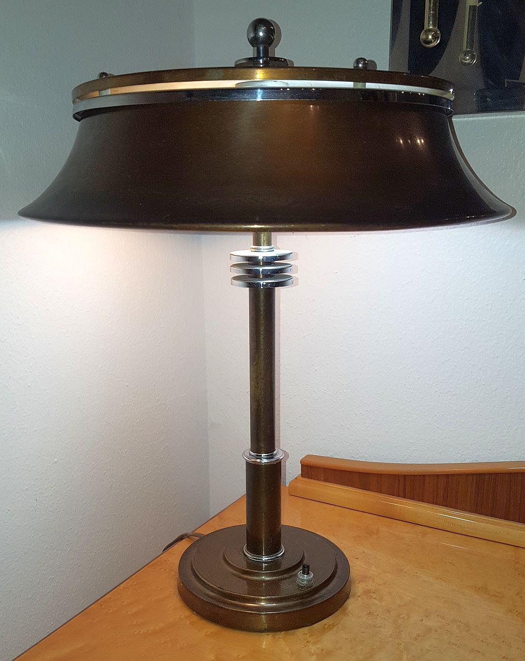 His is an original American Art Deco Machine Age table lamp that was designed and produced in the 1930's by the Markel Company of Buffalo, New York.
 
The three “speed” rings on the shaft are echoed in the typical Markel finial.
 
The lamp is