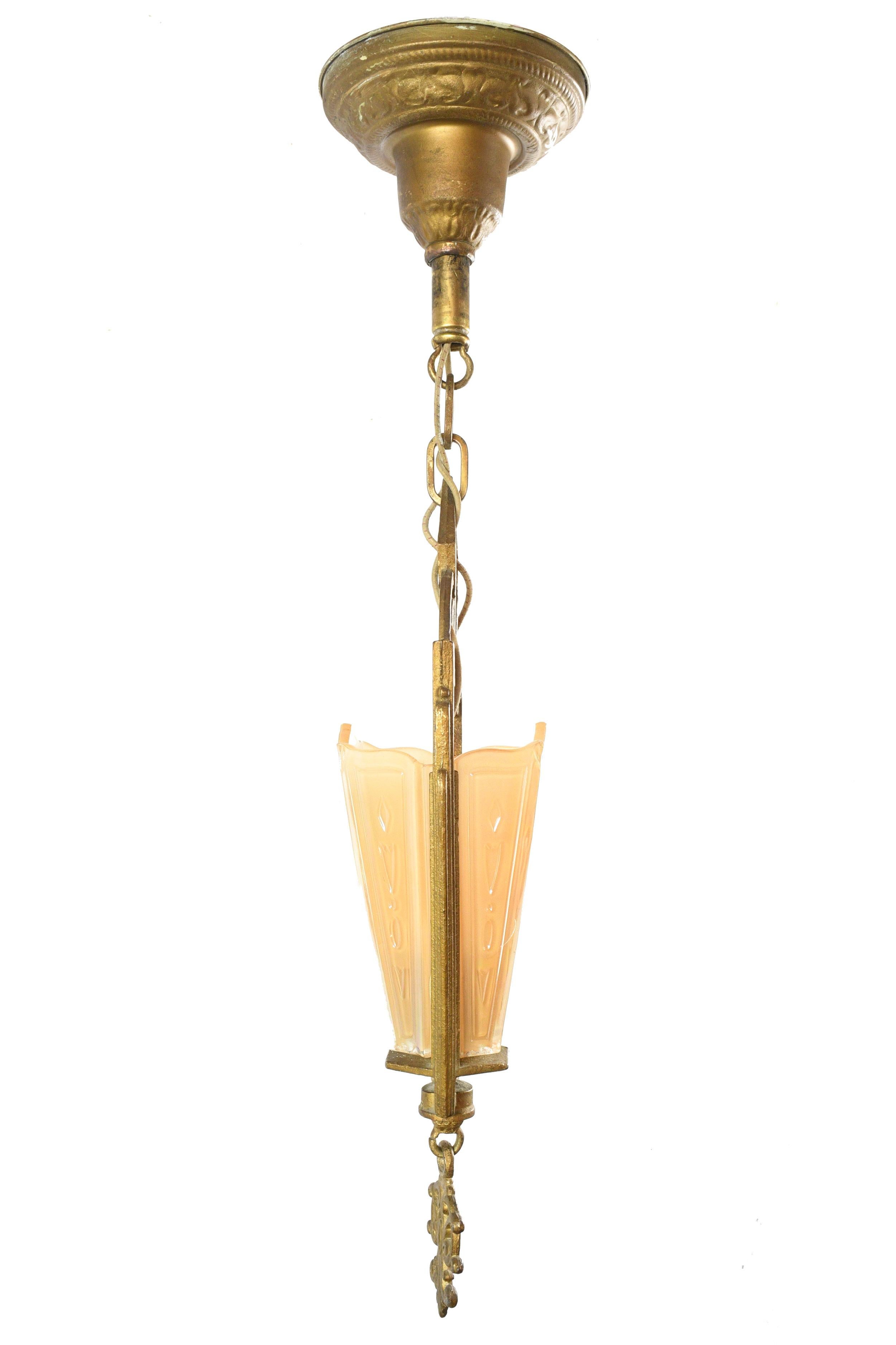 This precious single candle Art Deco pendant made by Markel Company, well known for their Art Deco and Art Nouveau slipper shade chandeliers and sconces. A nude/peach coloured iridescent shade sits delicately in a geometric Art Deco frame with a