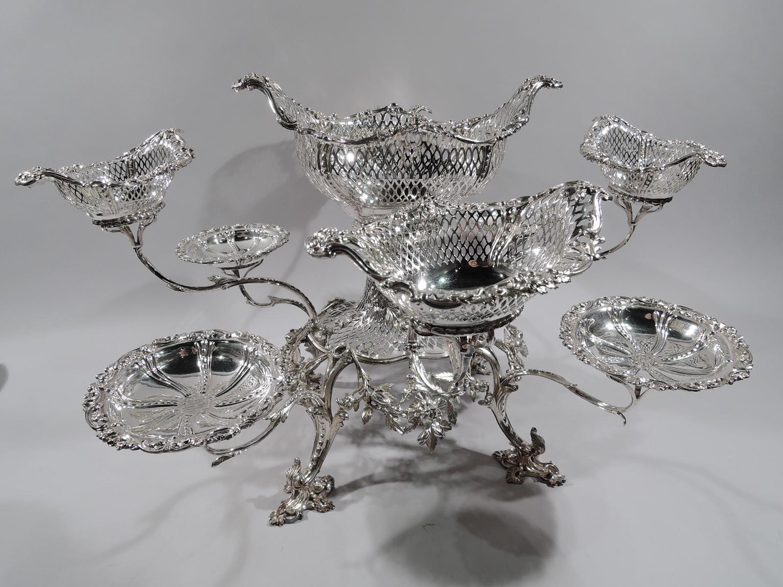 Market-fresh George III sterling silver epergne. Made by Thomas Pitts in London in 1766. Pierced and oval support set in round floral garland frame with four leafing scroll supports on same feet. Large and pierced oval basket, surrounded by