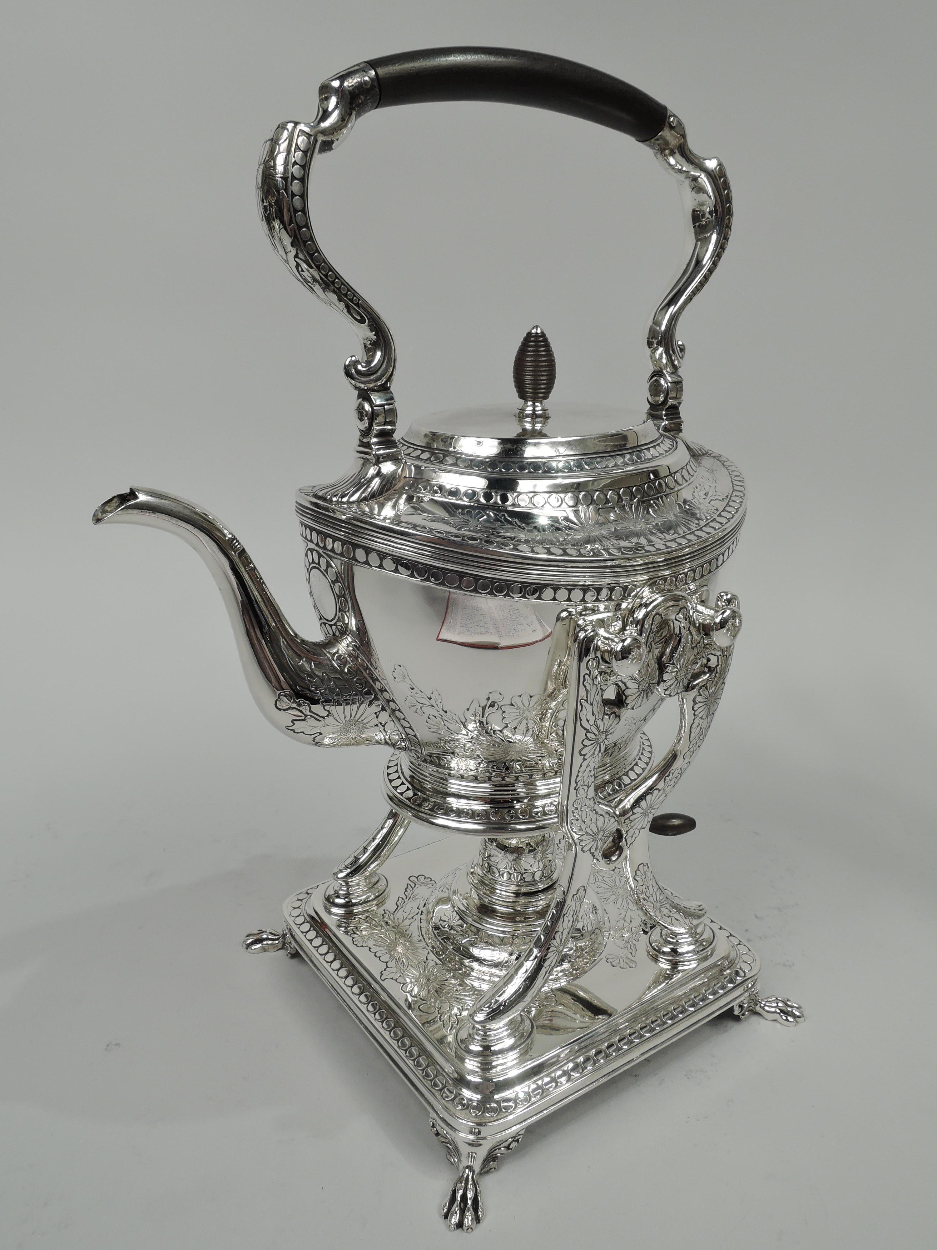 Market-fresh Aesthetic sterling silver tea kettle on stand. Made by Tiffany & Co. in New York, ca 1910. Ovoid body with raised, flat, and hinged cover and stained-wood beehive finial. Swing scroll handle and s-scroll spout. Open stretchers on