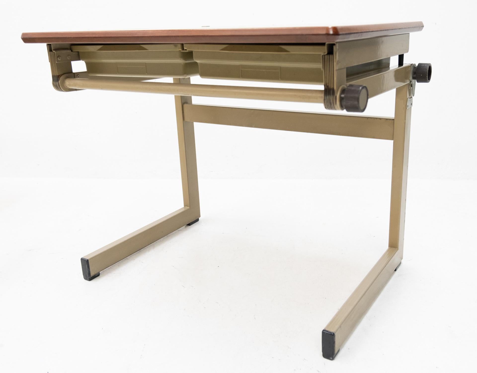 Small Industrial writing table. Marko Holland 1960s folding out. So you can work standing up.
Handy pin to hold the paper. Small in size, very handy in use. For the artist or architect or student.
Brown resin top. Two drawers. Good working