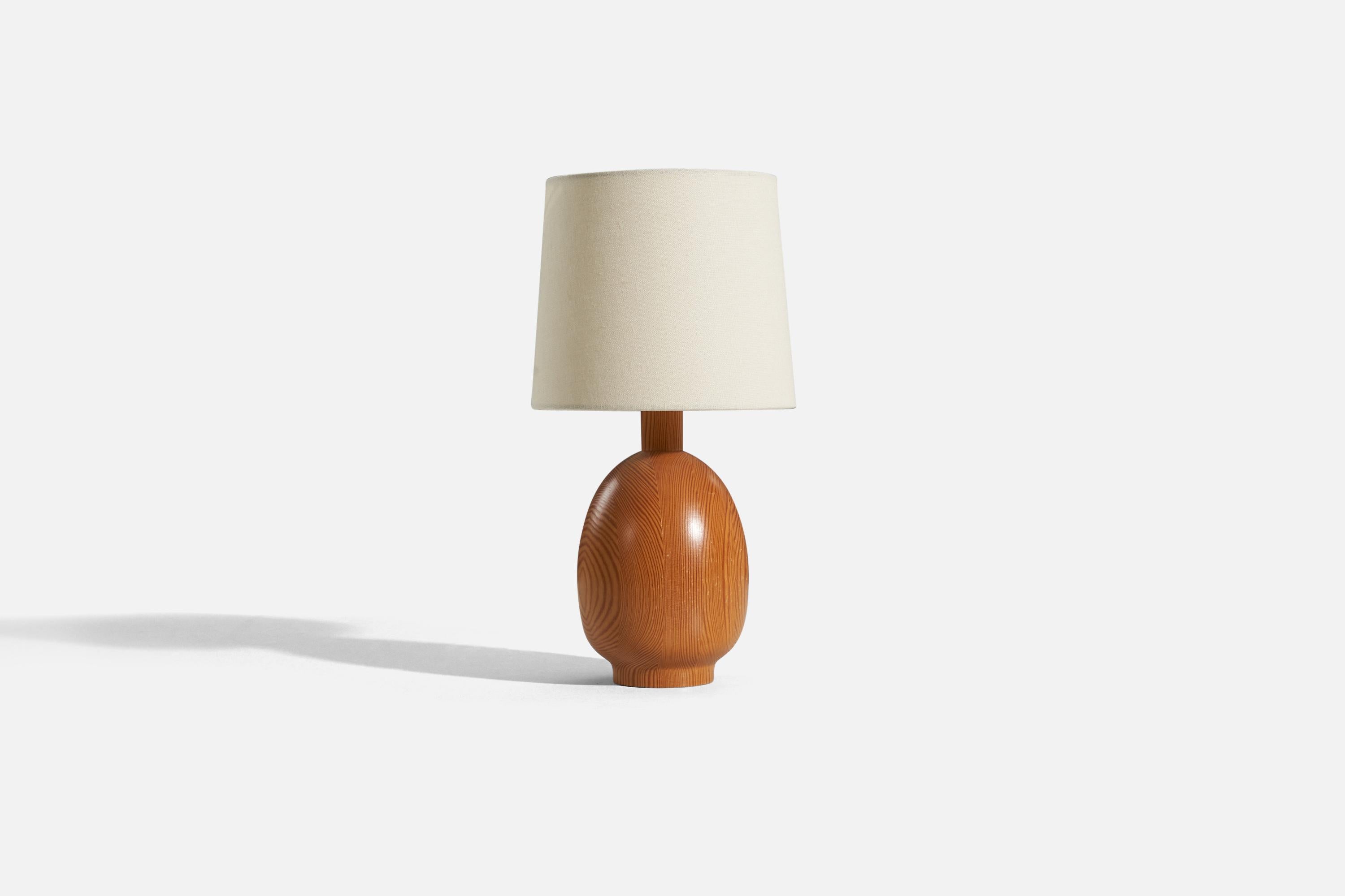 A solid pine table lamp designed and produced by Markslöjd, Kinna, Sweden, c. 1970s.

Sold without lampshade. 
Dimensions of Lamp (inches) : 11.3125 x 5 x 5 (H x W x D)
Dimensions of Shade (inches) : 7 x 8 x 7 (T x B x H)
Dimension of Lamp with