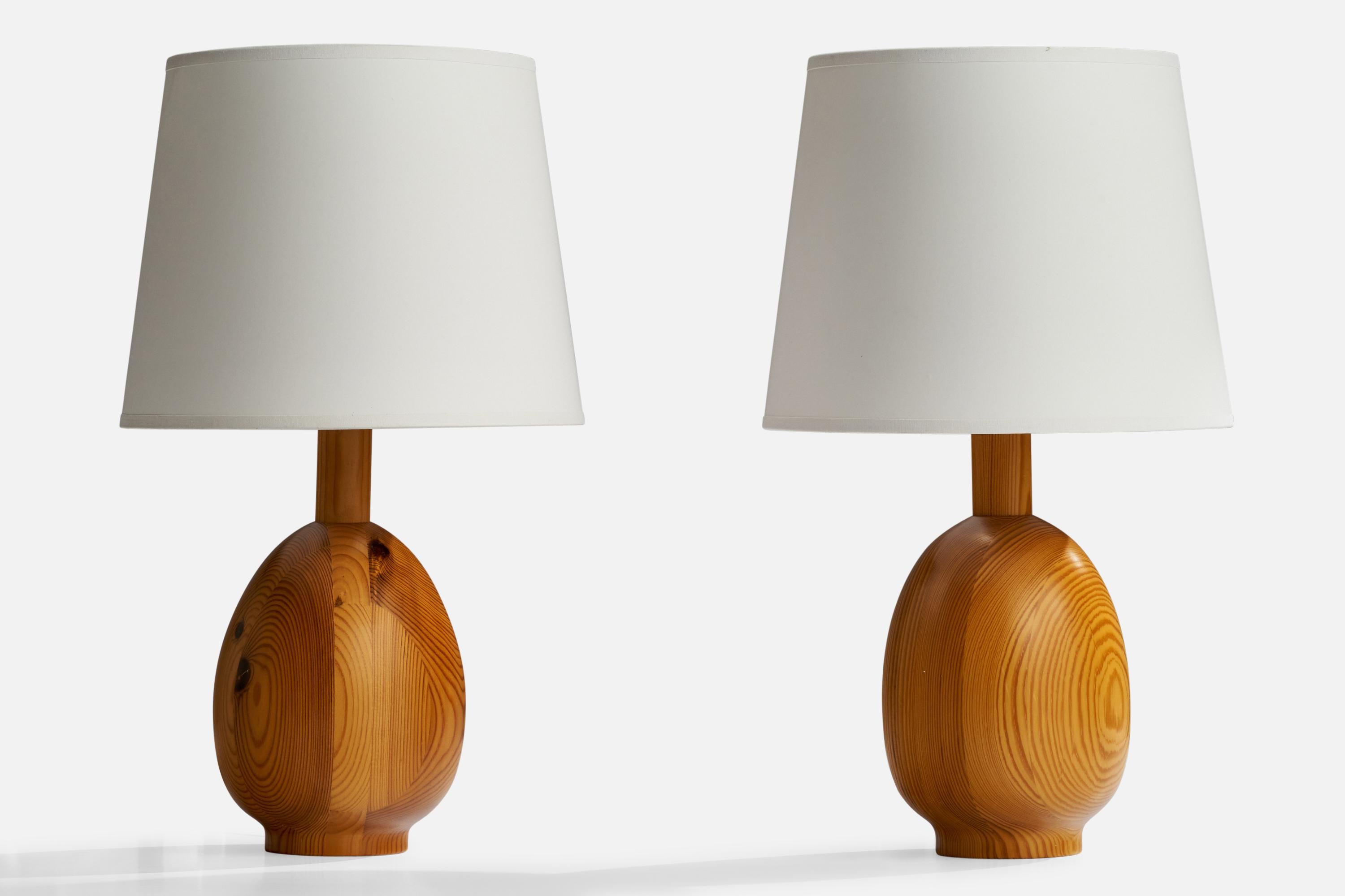 A pair of pine table lamps designed and produced by Markslöjd, Sweden, c. 1970s.

Dimensions of Lamp (inches): 11.5” H x 5” Diameter
Dimensions of Shade (inches): 8”  Top Diameter x 10” Bottom Diameter x 8” H
Dimensions of Lamp with Shade (inches):
