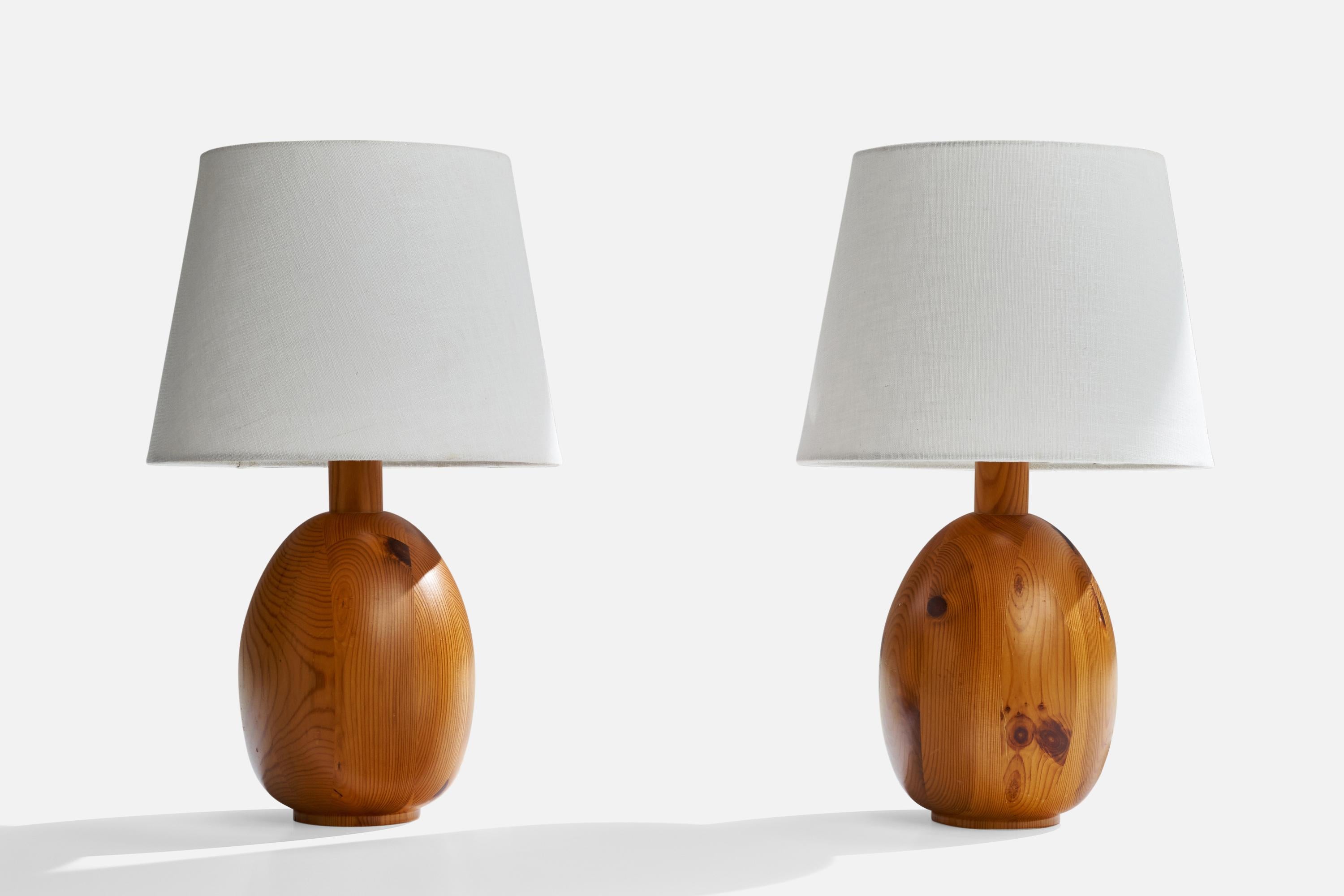 A pair of pine table lamps designed and produced by Markslöjd, Sweden, 1970s.

Dimensions of Lamp (inches): 14” H x 7” Diameter
Dimensions of Shade (inches): 9” Top Diameter x 12” Bottom Diameter x 9” H 
Dimensions of Lamp with Shade (inches): 19.5”