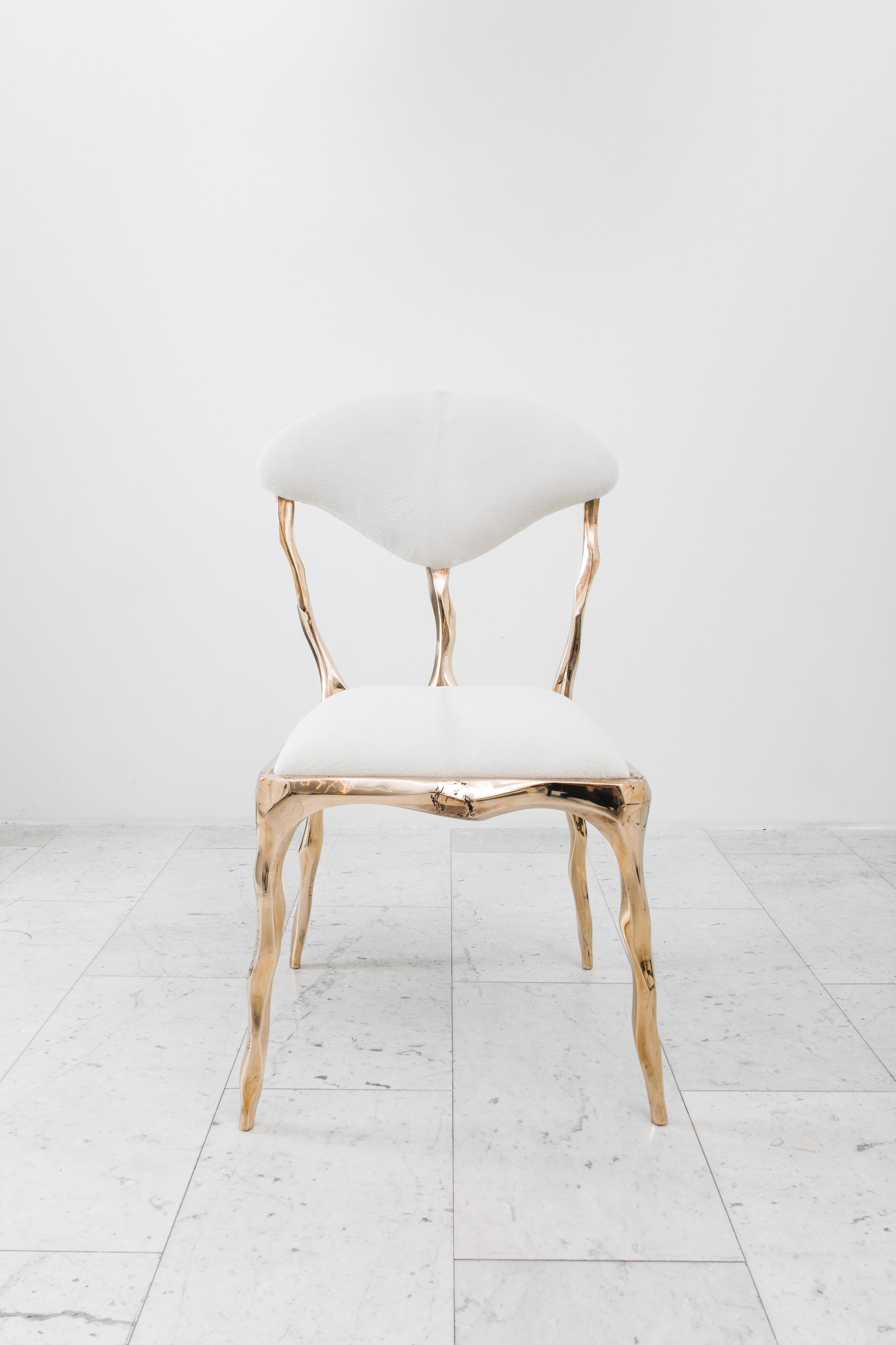 Taking inspiration from the twisting forms of seaweed and other natural materials, Haase hand-carves each element of his unique dining chair before casting it in his New York City studio.  The bronze components are then welded together by the artist