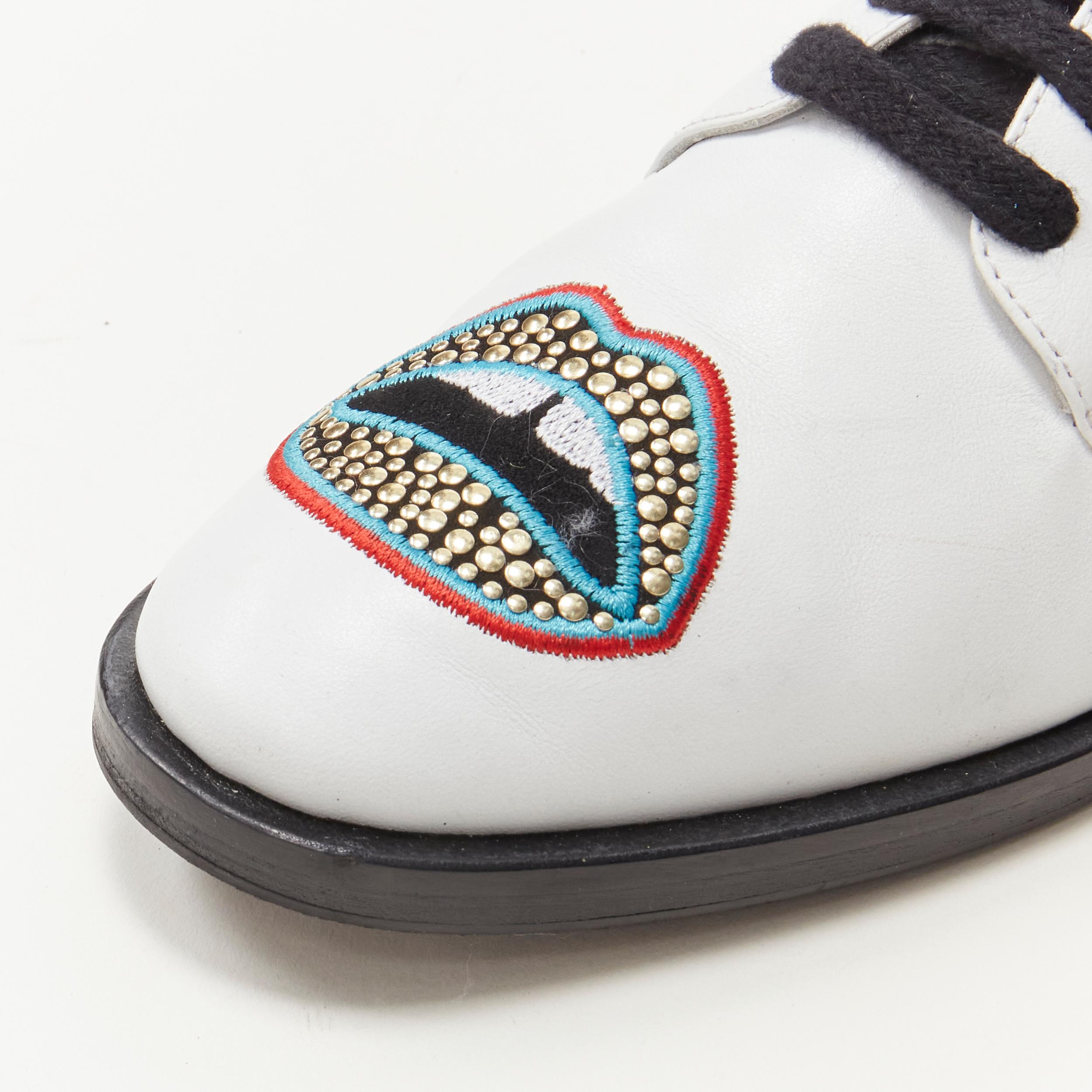 MARKUS LUPFER Signature studded embroidered lips white leather brogue EU36 
Reference: ANWU/A00170 
Brand: Markus Lupfer 
Material: Leather 
Color: White 
Pattern: Solid 
Closure: Lace up 
Extra Detail: Stacked wooden sole. 


CONDITION: 
Condition: