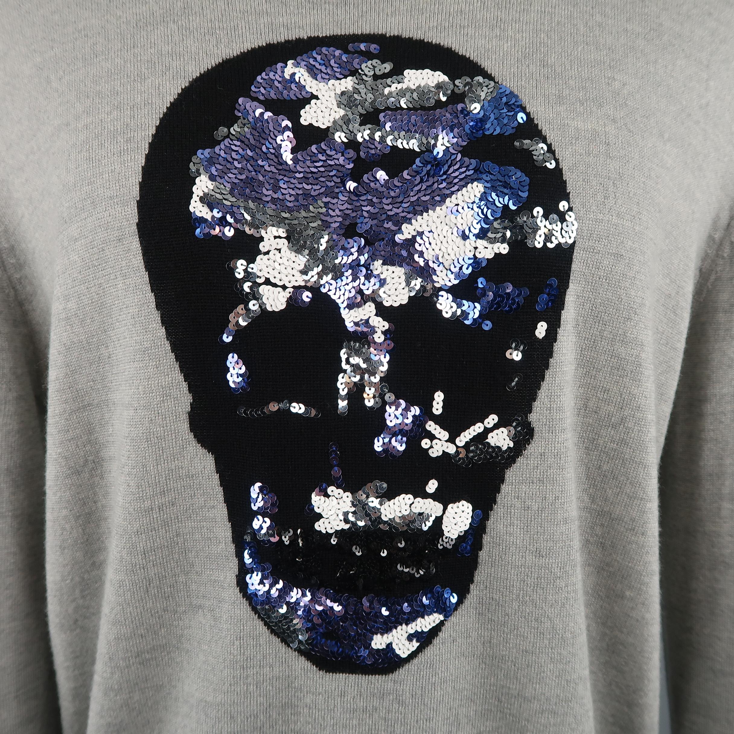 MARKUS LUPFER pullover sweater comes in light gray merino wool knit with a crewneck and black skull graphic embellished with blue and white sequin.
 
Excellent Pre-Owned Condition.
Marked: (no size)
 
Measurements:
 
Shoulder: 20 in.
Chest: 42