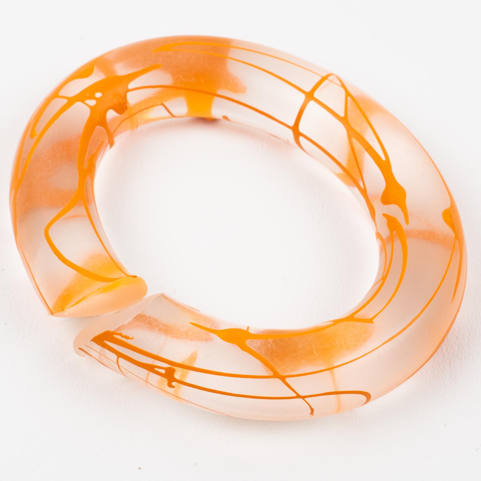 This is a rare English designer Marlene McKibbin Lucite or Acrylic bracelet bangle. This bracelet has a frosted translucent color with an open spiral design and has an orange acrylic screening ink application. 
Measurements: inside across is 2.75
