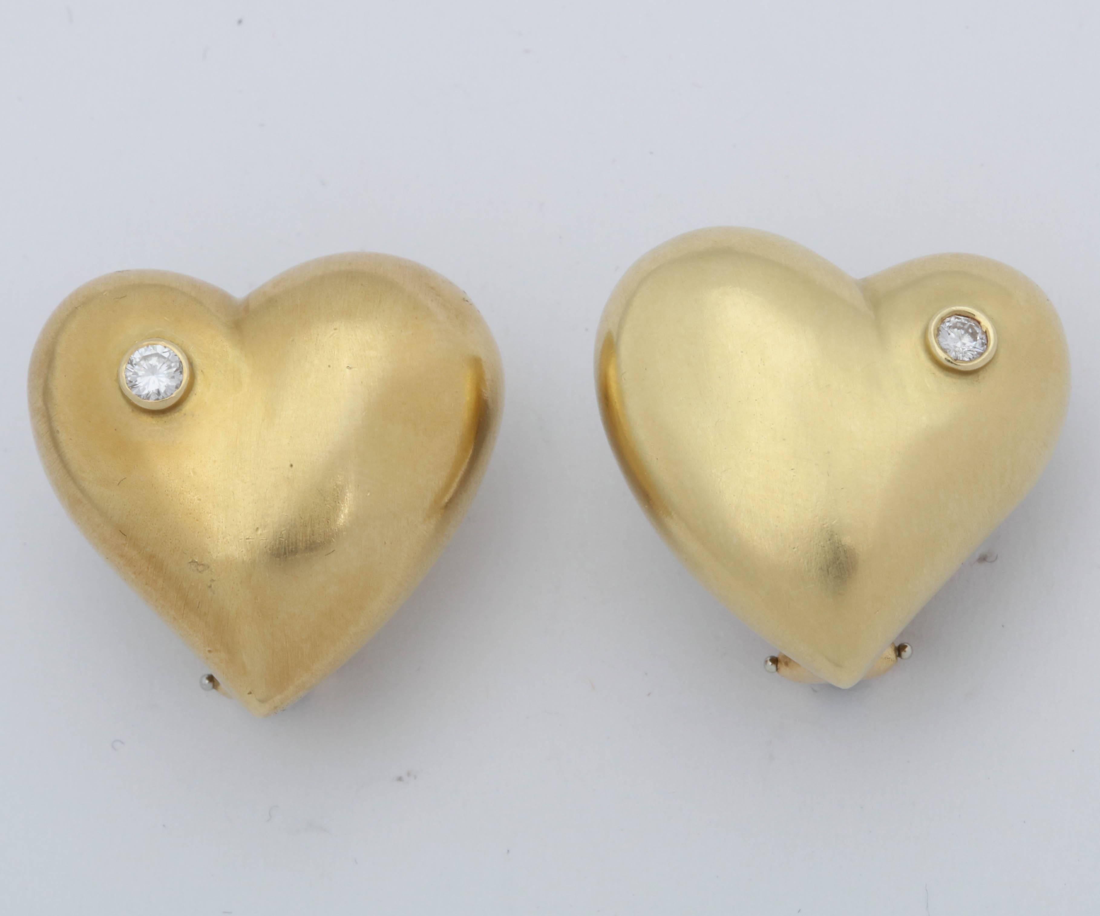 One Pair Of Ladies 18kt Yellow Gold hand Hammered Puffy Heart Earrings Created With Two Bezel Set .5 Ct Full Cut diamonds In the Corner Of the Hearts. Note Earrings May Be Worn With diamonds Facing Your face Or worn with diamonds Facing The opposite