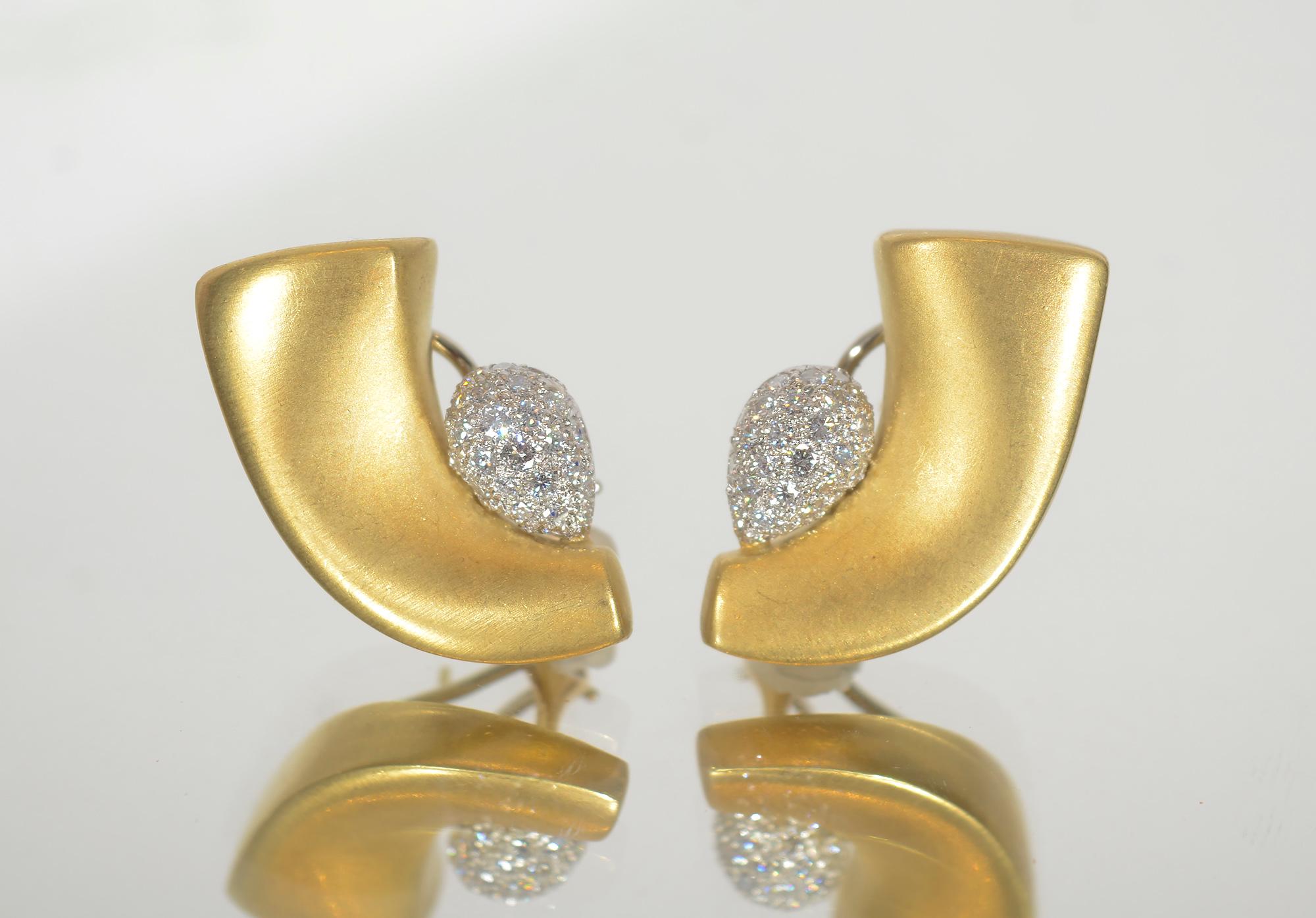 Crescent shaped 18 karat gold earrings  with a soft burnished finish by contemporary designer, Marlene Stowe.  Within the crescent is a pear shaped cluster of pave diamonds. The earrings measure 1 1/4 inches in length and 3/4  inch at the diamonds.
