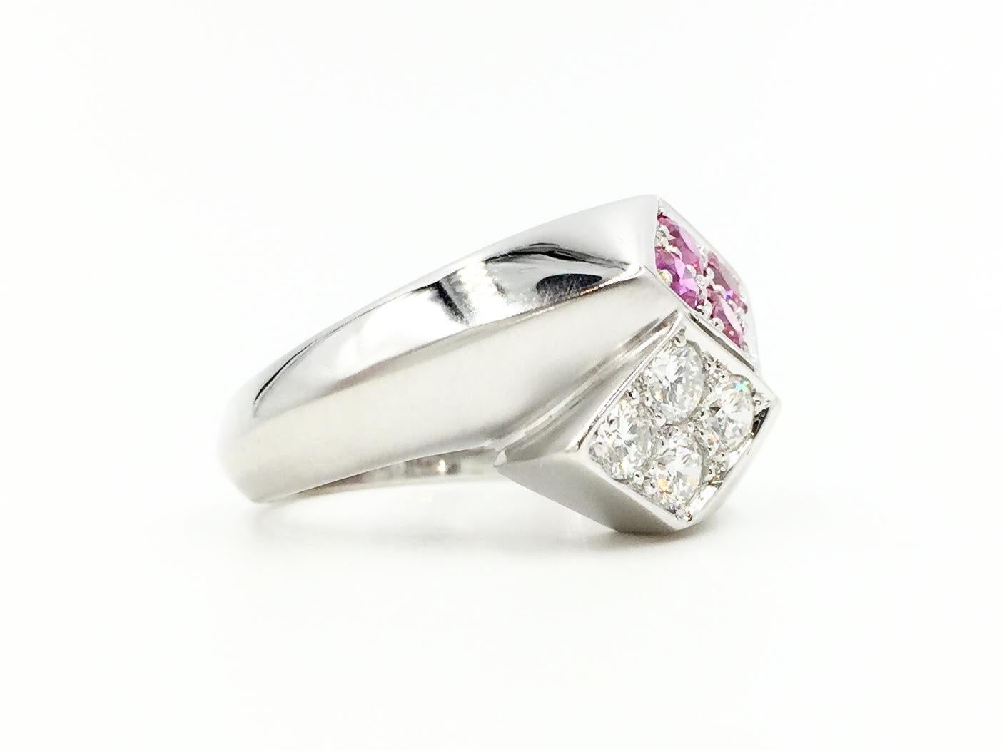 A fashionable and fun Marlene Stowe 18k white gold bypass wrap style ring featuring .56 carats of brilliant diamonds and .64 carats of bright pink sapphires. Ring has both design and dimension with a beautiful half satin, half high shine finish.